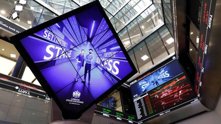 Tilted digital display inside the London Stock Exchange showing the message “Setting the stage for your success."